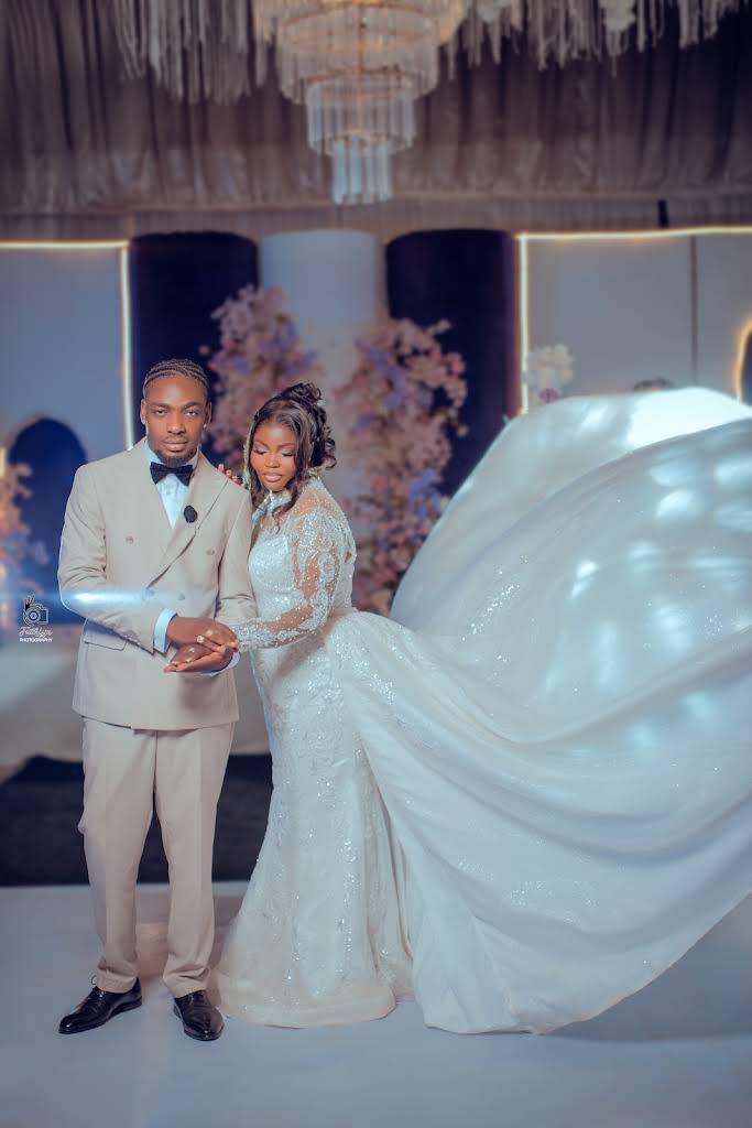 A bride and groom together in elegant wedding attire