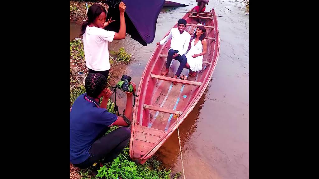 Photographer capturing a couple in a boat during an outdoor session